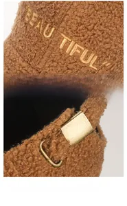 Detail of brown teddy fleece baseball cap with gold embroidery and metal buckle