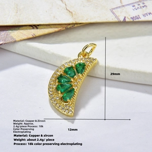 Detailed view of copper fan pendant with green zircon and 18k gold plating details