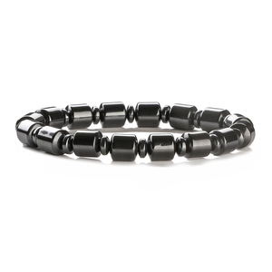 Polished black hematite beaded bracelet featuring cylindrical and disc-shaped beads