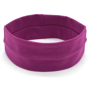 Detail of fuchsia wide yoga headband showing soft elastic knitted fabric texture