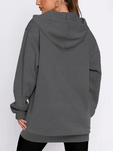 Rear view of oversized dark grey hooded sweatshirt showing loose fit and drape