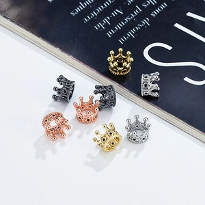 Macro shot of crown beads in gold, rose gold, silver, and black for DIY jewelry making