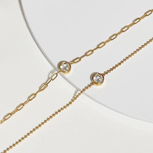 Detail showing paperclip and bead chains in 18k gold plating with bezel-set cubic zirconia