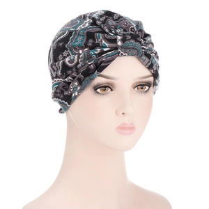Detailed view of paisley pattern turban hat with vintage black and grey floral design