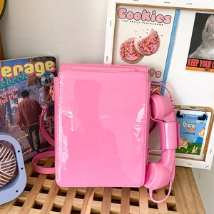 Detailed view of creative pink Y2K rotary phone crossbody bag with handset and spring cord