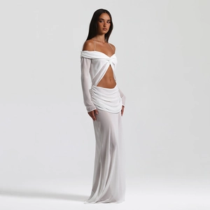Detail view of the twisted cutout waist and pleated texture on white chiffon maxi dress
