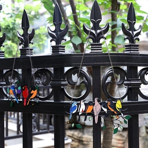 Colorful stained glass suncatcher with 4 and 7 birds hanging on iron fence decor