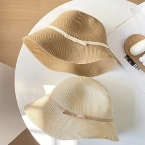 Women's straw sun hat with bow ribbon detail for beach sun protection and casual wear