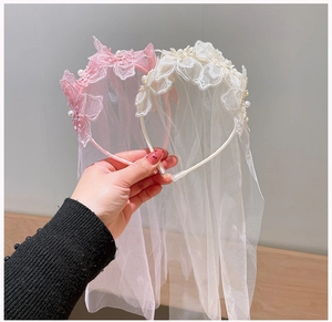 Detail of girls princess tiara headbands with lace flowers, pearls and long tulle veils