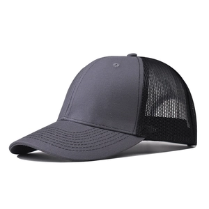 Detail view of a dark grey curved brim trucker hat with breathable black mesh back