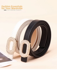 Detail of elegant black and white leather belts with pearl and rhinestone oval buckles