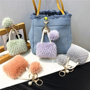 Detailed plush mini bag keychains with pearls and soft faux fur in pastel colors