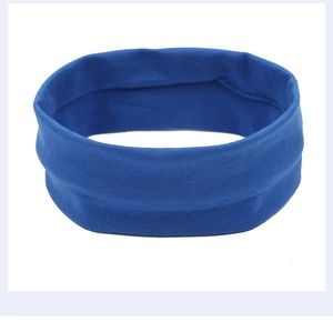 Detail of blue elastic wide headband with smooth moisture-wicking texture for sports