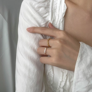 French minimalist ring set featuring gold textured band and four elegant white pearls