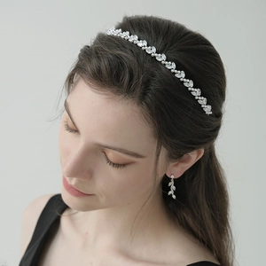 Elegant silver headband and earrings set with crystal leaves and delicate pearls