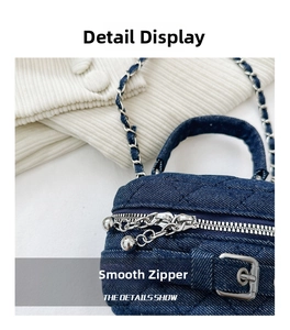 Detailed macro view of quilted denim handbag with smooth silver metal double zippers