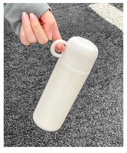 Minimalist white stainless steel insulated bottle featuring a portable handle design