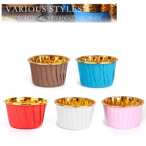 Various colored muffin liners with non-stick gold foil interior on white background