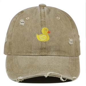 Close-up of yellow duck embroidery and vintage distressed details on khaki cotton cap