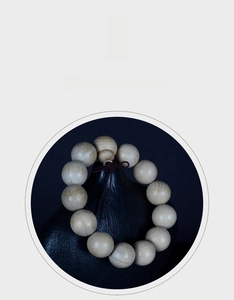 Detail of natural wood beads bracelet with visible grain texture and handmade knot