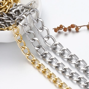High-quality gold and silver curb chains hanging from a white ceramic bowl for jewelry
