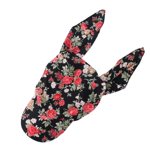 Close-up of floral headscarf featuring pink flowers and rabbit ear tie design