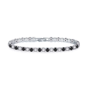 Detail of silver tennis bracelet with alternating black and white round-cut cubic zirconia