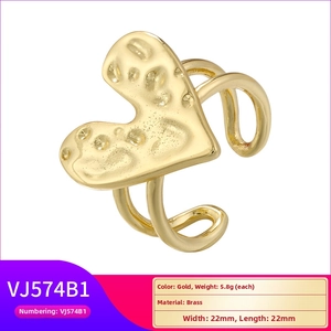 Detailed view of gold heart ring featuring a unique hammered texture and brass finish