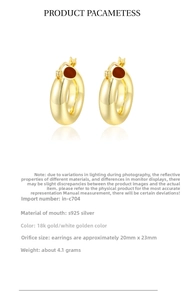 Macro detail of chunky C-shape S925 silver hoop earrings with 18k gold plating details