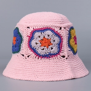 Detail of pink hand-crocheted bucket hat with colorful sunflower patterns and textures