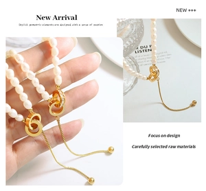 Detailed view of freshwater pearl necklace with gold double ring pendant and pavé crystals