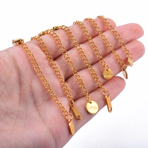 Hand holding golden stainless steel extension chain with lobster clasp and S.STEEL tag