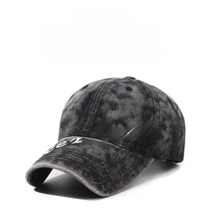 Detail of vintage washed gray baseball cap featuring white Luzzz letter embroidery