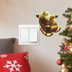 Detail showing colorful Santa Claus on a sleigh glowing wall sticker near a light switch