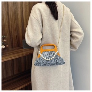 Retro grey tweed handbag with wooden handle and pearl chain shown on model