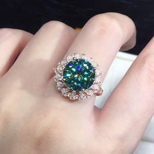 Macro detail of luxury rose gold ring featuring a cluster-set round green gemstone