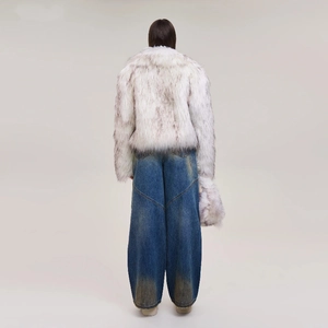 Close-up of vintage blue wide-leg jeans with distressed wash and frayed detailing