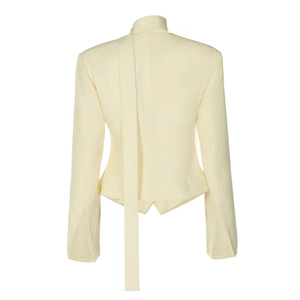 Detail view of cream tailored blazer back with elegant long neck ribbons and split cuffs
