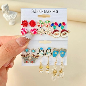 Close-up of Christmas earring set featuring festive reindeer, snowflake and santa designs