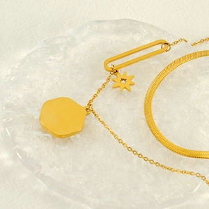 Vintage gold layered necklace with hexagram and geometric pendants on snake chain