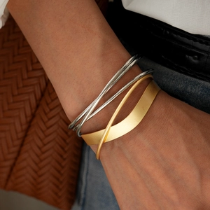 Minimalist stackable cuff bracelet set featuring gold and silver geometric layering