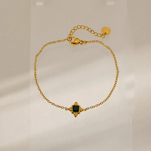 Detailed close-up of a square green gemstone pendant on a gold-plated stainless steel chain