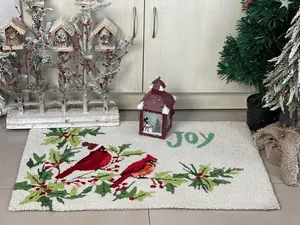 Detail of Christmas cardinal rug with soft faux cashmere texture and Joy lettering