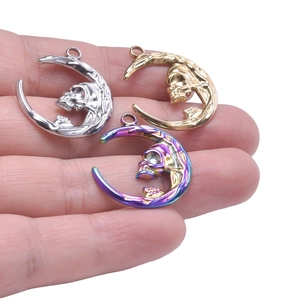 Polished stainless steel moon and skull pendants in gold, silver, and rainbow colors