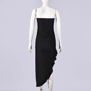 Close-up of the ruffled hem and irregular asymmetric cut on this black bodycon dress