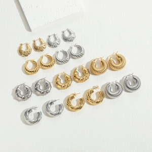 Collection of geometric titanium steel earrings in gold and silver with various textures