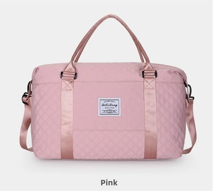 Detailed front view of pink quilted travel bag with large capacity for fitness