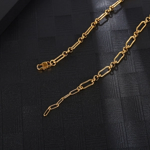 Macro detail of golden paperclip chain link texture and lobster clasp on titanium steel necklace