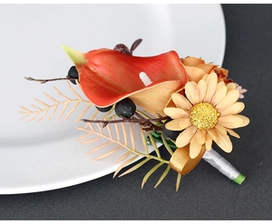 Detail of handmade calla lily and daisy boutonniere with elegant silk-wrapped stem