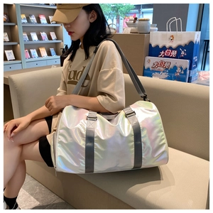 Detailed view of a silver holographic gym bag with gray straps used by a model